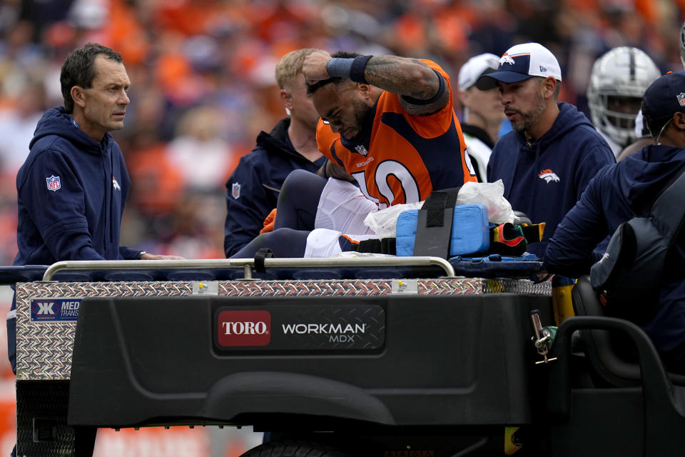 Denver Broncos safety Caden Sterns (30) slams his fist on the cart as he is carted off the field after an injury against the Las Vegas Raiders during the first half of an NFL football game, Sunday, Sept. 10, 2023, in Denver. (AP Photo/Jack Dempsey)