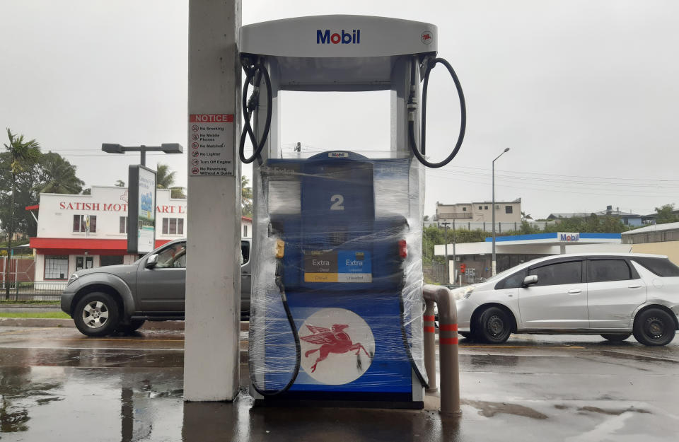 A gas pump is wrapped in the preparation for cyclone Yasa in Suva, Fiji, Thursday, Dec. 17, 2020. Fiji was urging people near the coast to move to higher ground Thursday ahead of a nationwide curfew as the island nation prepared for a major cyclone to hit.(AP Photo/Aileen Torres-Bennett)