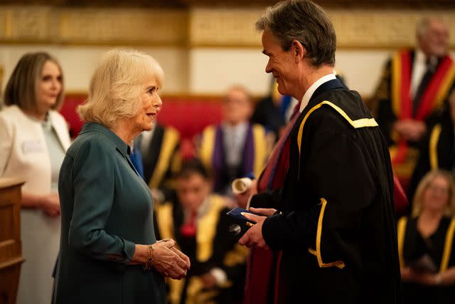 <p>Aaron Chown-WPA Pool/Getty</p> Queen Camilla presents the Queen's Anniversary Prize to representatives from the Institute of Cancer Research, London, during an event to present the Queen's Anniversary Prizes for Higher and Further Education, at Buckingham Palace on February 22, 2024.