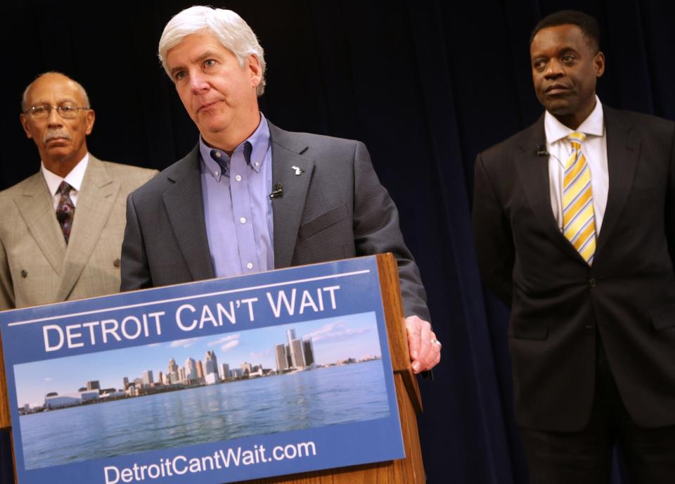 Governor Rick Snyder speaks at a press conference to announce that Washington, D.C. lawyer Kevyn Orr, 54, right, is being named as the emergency financial manager for the city of Detroit at the Cadillac Center in Detroit, Thursday, March 14, 2013. Then Detroit mayor Dave Bing stands to the left of the podium.