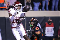 Oklahoma wide receiver Brian Darby (16) catches a touchdown pass in front of Oklahoma State safety Jason Taylor II (25) during the first half of an NCAA college football game Saturday, Nov. 27, 2021, in Stillwater, Okla. (AP Photo/Sue Ogrocki)