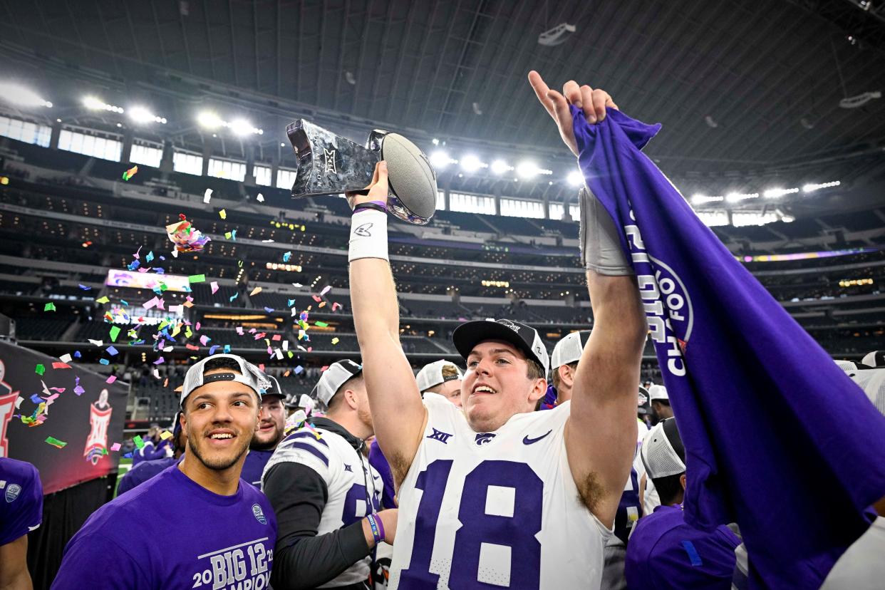 Kansas State quarterback Will Howard (18) raises the Big 12 championship trophy after the Wildcats' overtime victory over TCU last December in Arlington, Texas.