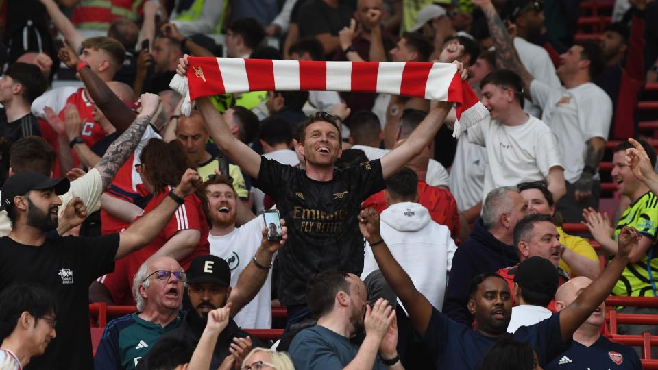 Arsenal fans celebrate their team's victory at Manchester United