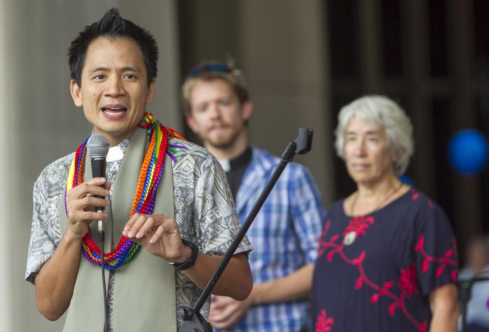 Rev. Dr. Jonipher Kupono Kwong of the First Unitarian Church of Honolulu, stands along several others of Hawaii's clergy and speaks to attendees at an "All You Need is Love" rally at the Hawaii State Capitol in Honolulu