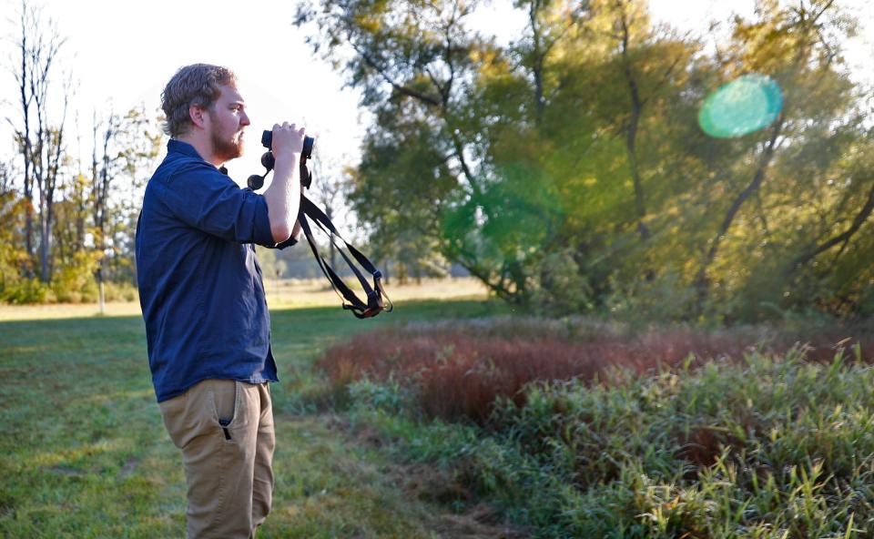 Eagle Creek Ornithology Center Manager Will Schaust looks for birds at Eagle Creek Park, Wednesday, Sept. 18, 2019.