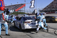 The pit crew for Ross Chastain rush to complete a pit stop during a NASCAR Cup Series auto race at Darlington Raceway, Sunday, May 12, 2024, in Darlington, S.C. (AP Photo/Matt Kelley)