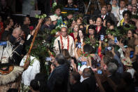 New Zealand Prime Minister Jacinda Ardern, center right, takes part in a ceremony in Auckland, Sunday, Aug. 1, 2021, to formally apologize for a racially charged part of the nation's history known as the Dawn Raids. The Dawn Raids are known as the time when the Pasifika people were targeted for deportation in the mid-1970s during aggressive home raids by authorities to find, convict and deport visa overstayers. (Brett Phibbs/New Zealand Herald via AP)