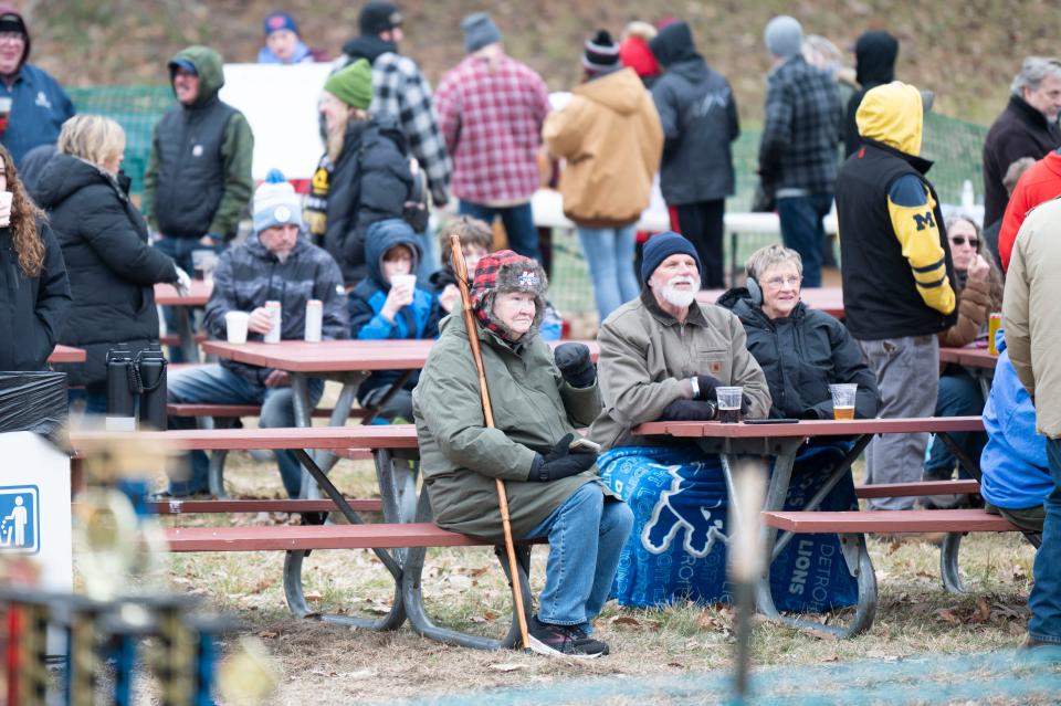 Spectators watch races from the beer garden picnic tables during the Festivus Cardboard Sled Competition at Leila Arboretum on Saturday, Feb. 10, 2024.
