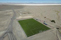 A soccer field sits in the desert near Peine, Chile, Thursday, April 20, 2023. Peine resident Ramon Torres says, “There is development, but there’s also the water issue. And they contradict each other. … Because everyone needs money, everyone also needs the basics, like healthcare and education.” (AP Photo/Rodrigo Abd)