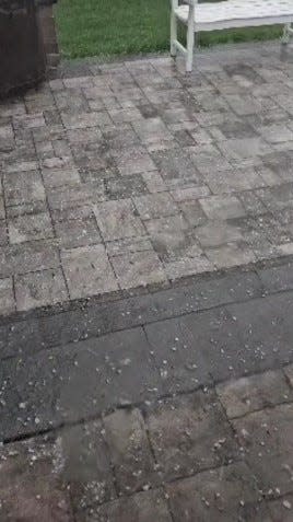 Hail, some dime-sized, pelts a backyard patio late Wednesday afternoon, April 17, during a heavy thunderstorm that moved through Jefferson Township in far eastern Franklin County.