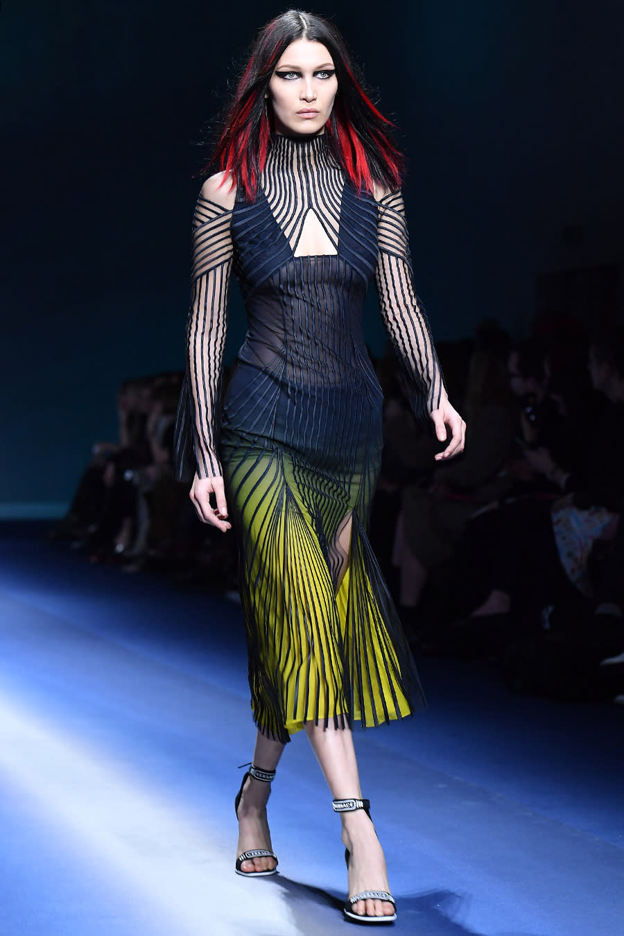 <p>The younger Hadid sister went edgy for Versace with red extensions in her ultra-dark locks. Heavy liner on her lids and a sharp contour on her cheekbones polished off the look.</p>