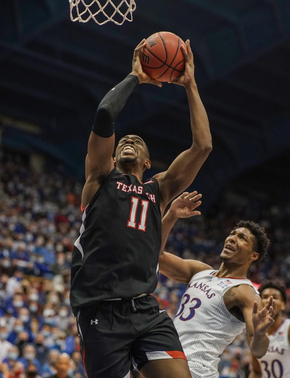 Jan 24, 2022; Lawrence, Kansas, USA; Texas Tech Red Raiders forward Bryson Williams (11) shoots as Kansas Jayhawks forward David McCormack (33) looks on during the first half at Allen Fieldhouse. Mandatory Credit: Denny Medley-USA TODAY Sports ORG XMIT: IMAGN-462497 ORIG FILE ID:  20220124_tdc_sm8_0229.JPG