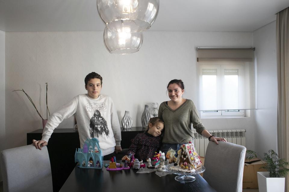 Siblings Martim Agostinho, Mariana Agostinho and Claudia Agostinho, pose for a picture at their home in Leiria, Portugal, Dec. 17, 2017. They are three of the six young people from Portugal arguing on Wednesday, Sept. 27, that governments across Europe aren't doing enough to protect people from the harms of climate change at the European Court of Human Rights. (AP Photo/Ana Brigida)