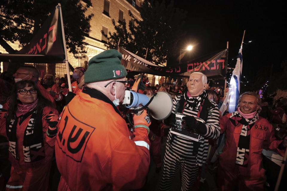 Israeli protesters chant slogans during a demonstration against Israeli Prime Minister Benjamin Netanyahu In Jerusalem, Saturday, Jan. 23, 2021. (AP Photo/Sebastian Scheiner)