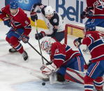 Montreal Canadiens goaltender Sam Montembeault (35) stops a goal attempt by Columbus Blue Jackets center Boone Jenner (38) during the first period of an NHL hockey game in Montreal, Saturday, March 25, 2023. (Peter McCabe/The Canadian Press via AP)