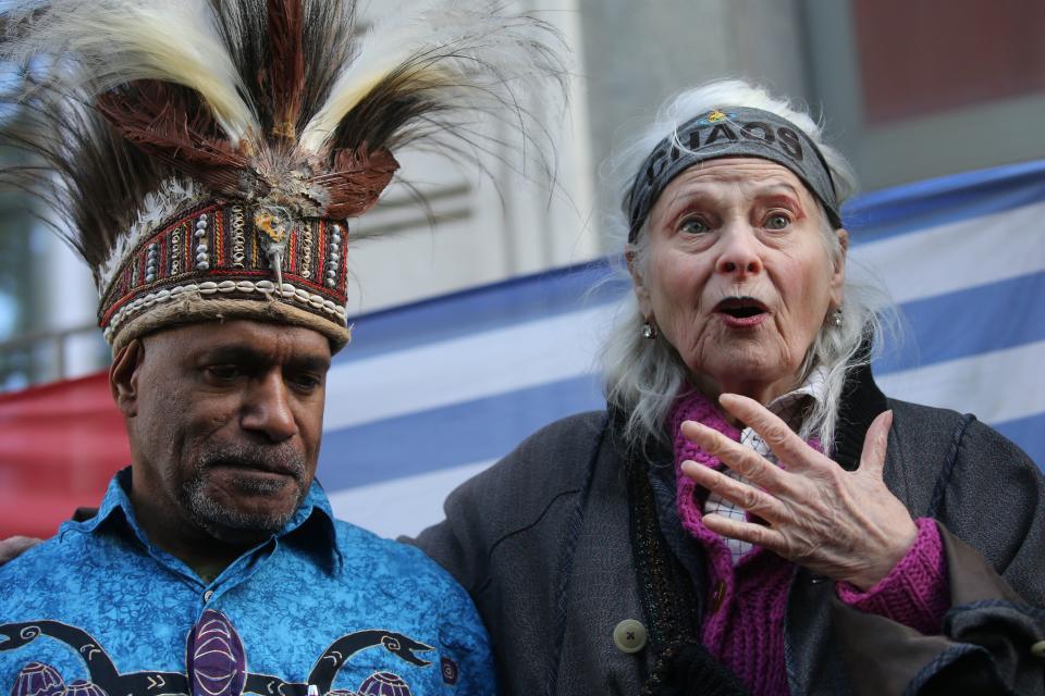 <p>British designer Vivienne Westwood, (R), gestures with West Papua activist Benny Wenda (L) during a protest action to highlight the exploitation of the West Papua rainforest and the continued presence of BP in the area, outside the headquarters of BP in London, on October 18, 2019</p> (AFP via Getty Images)