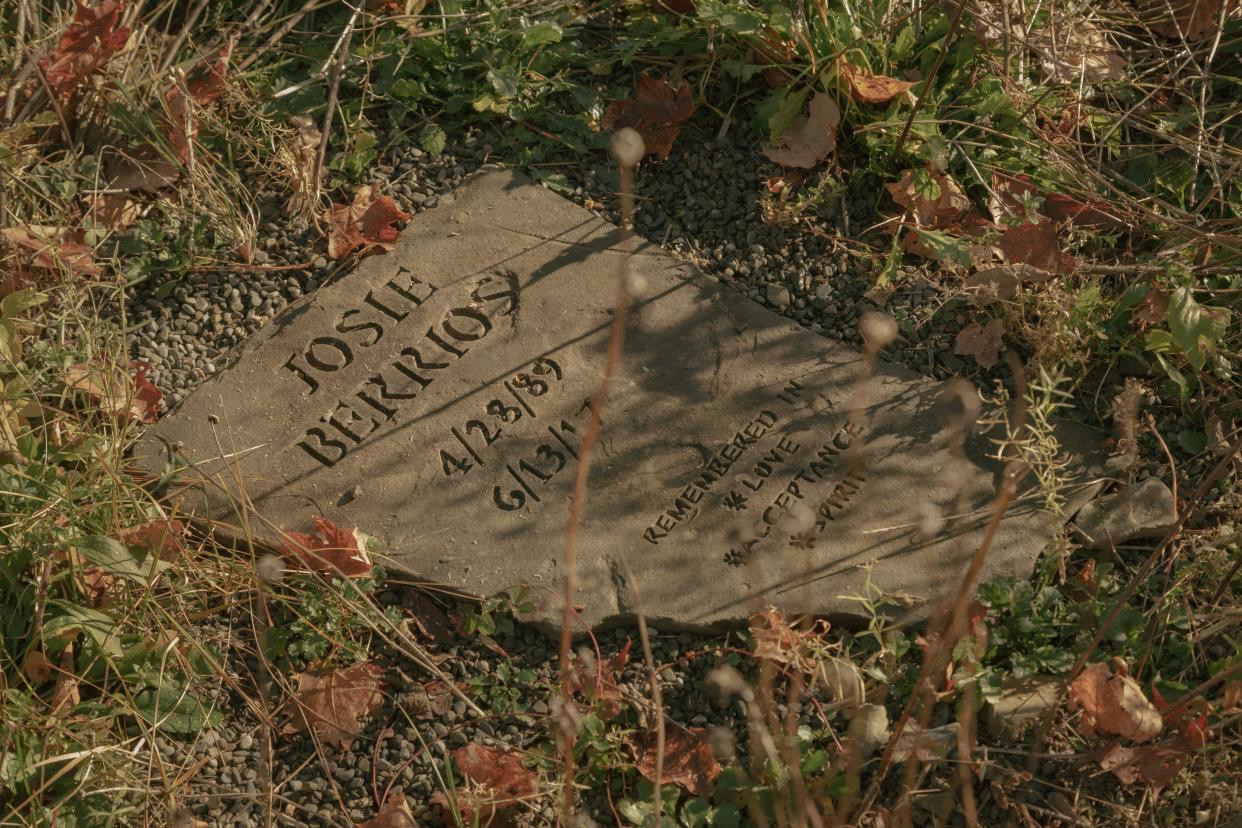 A gravestone for Josie Berrios in the sunlight surrounded by grass.