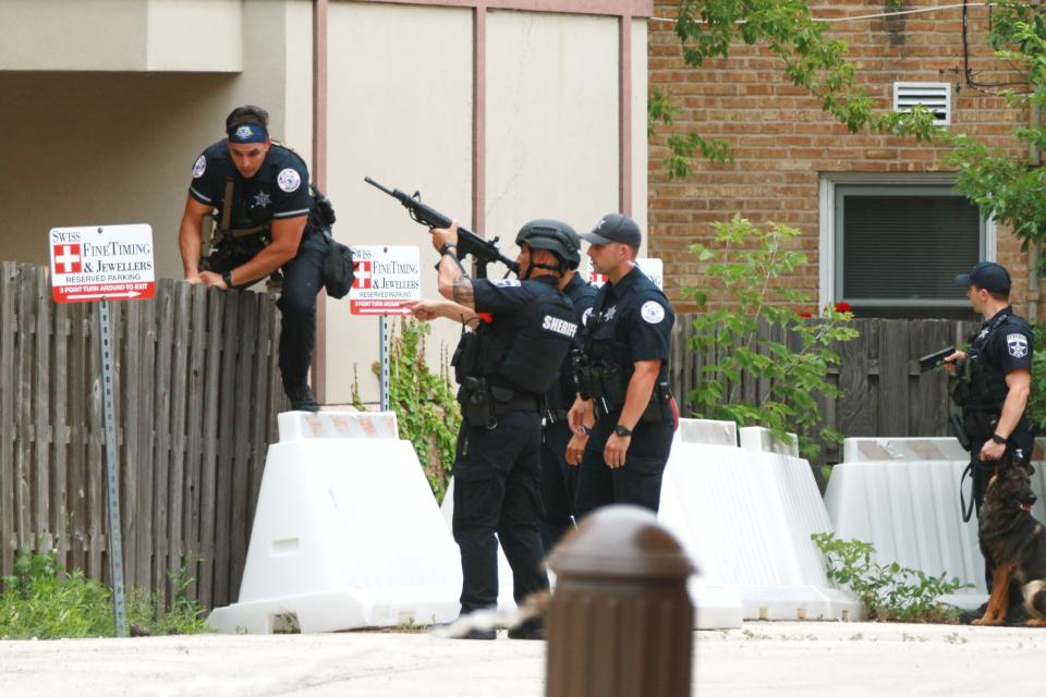 Law enforcement search the area of a shooting at a Fourth of July parade on 4 July 2022 in Highland Park, Illinois (Getty Images)