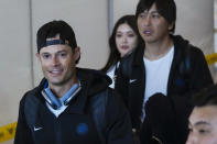 CORRECTS NAME OF PERSON BEHIND JOE KELLY TO IPPEI MIZUHARA, INTERPRETER FOR SHOHEI OHTANI, INSTEAD OF YOSHINOBU YAMAMOTO - Los Angeles Dodgers pitchers Joe Kelly, left, and Ippei Mizuhara, interpreter for Shohei Ohtani, walk through a terminal during the baseball team's arrival at Incheon International Airport, Friday, March 15, 2024, in Incheon, South Korea, ahead of the team's baseball series against the San Diego Padres. (AP Photo/Ahn Young-joon)