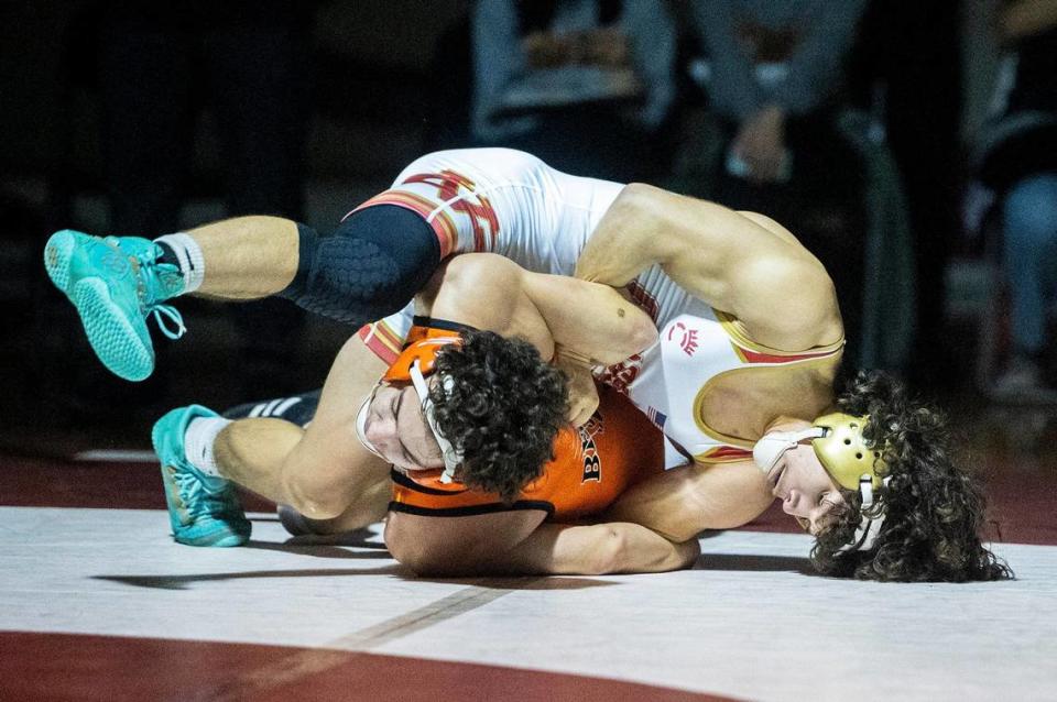 Golden Valley’s Jacob Partida wrestles Merced’s Jeremy Barrow during a match at Golden Valley High School in Merced, Calif., on Tuesday, Jan. 23, 2024.