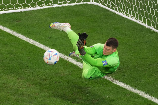 AL RAYYAN, QATAR - DECEMBER 09: Dominik Livakovic of Croatia saves the penalty during the penalty shoot out in the FIFA World Cup Qatar 2022 quarter final match between Croatia and Brazil at Education City Stadium on December 09, 2022 in Al Rayyan, Qatar. (Photo by Etsuo Hara/Getty Images)