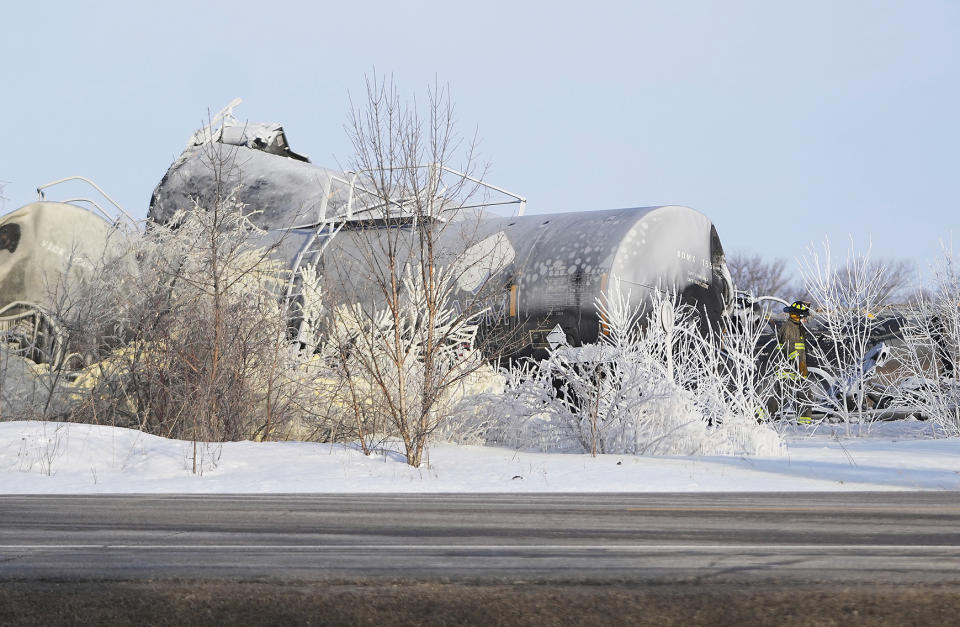 Emergency personnel respond to the scene after a BNSF train derailed in Raymond, Minn., Thursday, March 30, 2023. The train hauling ethanol and corn syrup derailed and caught fire early Thursday and nearby residents were ordered to evacuate their homes, authorities said.(David Joles /Star Tribune via AP)