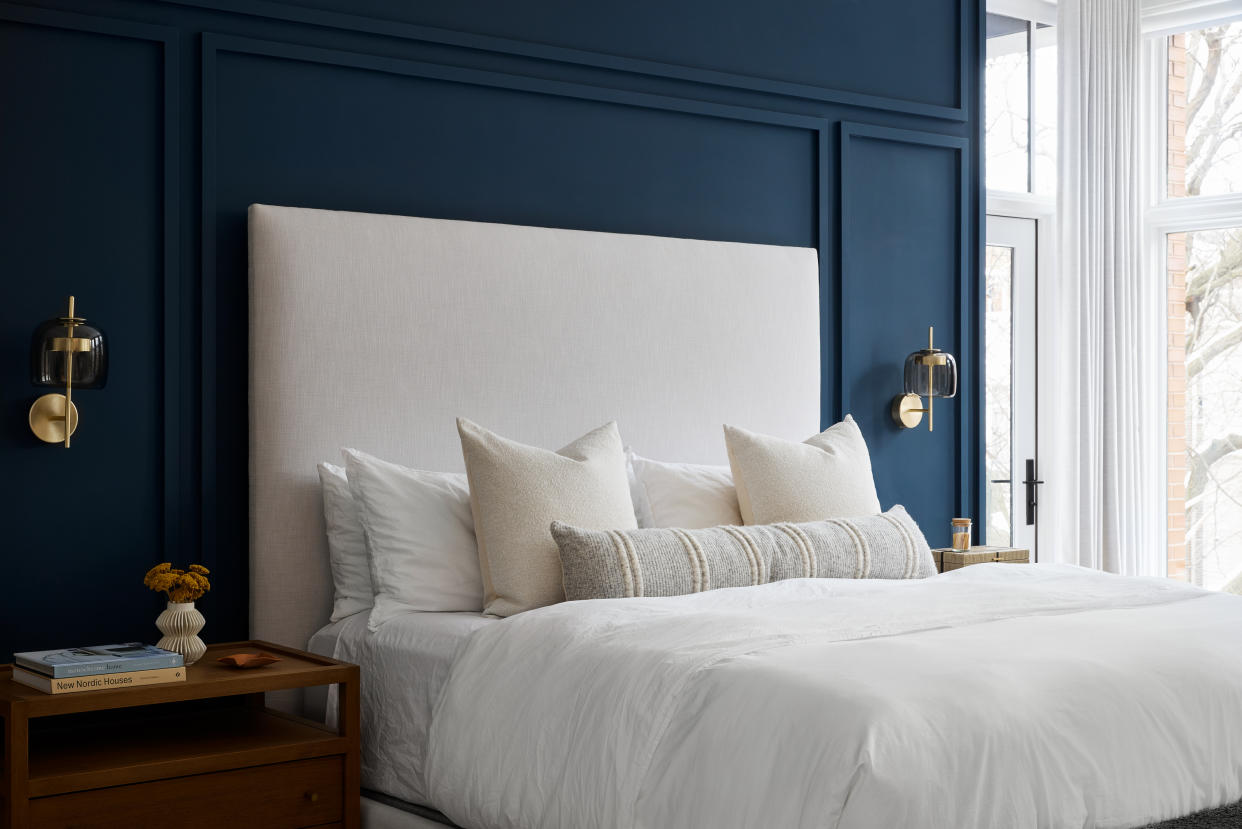  A bedroom with a navy blue accent wall. 