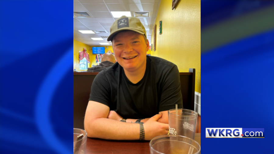A photo of Alexander Cook sitting at a table in a restaurant establishment. The photo is on a blue WKRG.com background.