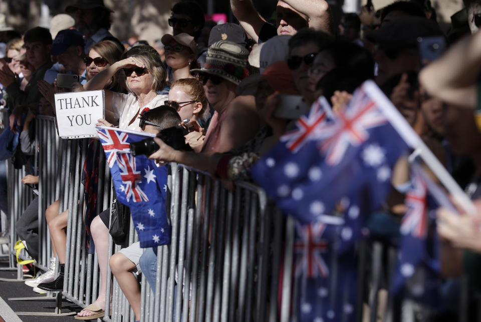 In this April 25, 2019, file photo, people line a street during a march celebrating ANZAC Day, a national day of remembrance in Australia and New Zealand that commemorates those that served and died in all wars, conflicts, and while peacekeeping, in Sydney, Australia. (AP Photo/Rick Rycroft, File)