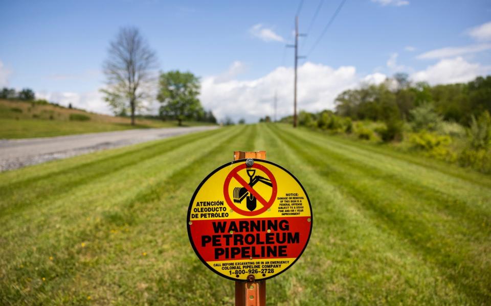 A sign marks the below-ground location of a Colonial Pipeline petroleum pipeline in Woodbine, Maryland, USA - Jim Lo Scalzo/Shutterstock