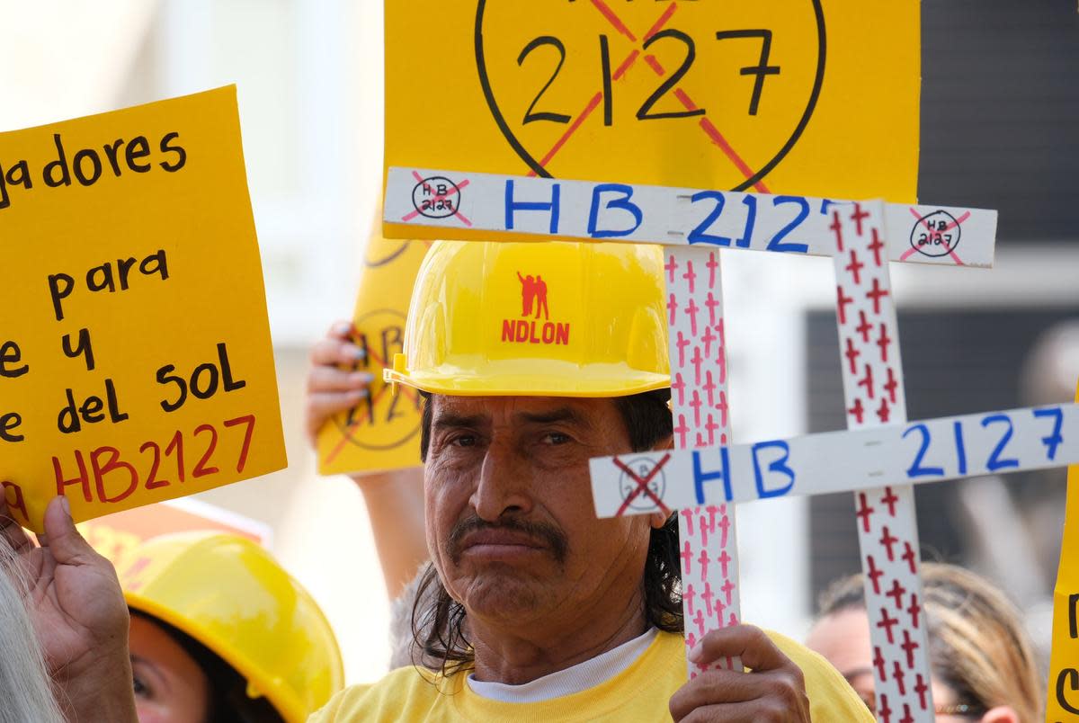 A members of Fe Y Justice Worker Center holds a sign in protest to HB-2127 during a press conference at Houston’s City Hall. Friday July 14, 2023.