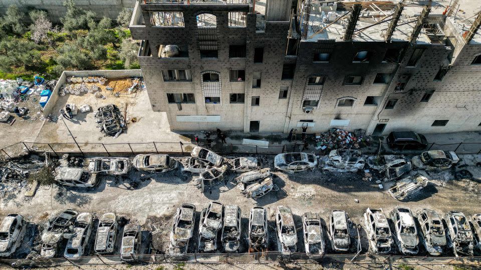 An aerial view of a scrapyard where cars were torched overnight, in the Palestinian town of Huwara near Nablus in the occupied West Bank on February 27. - Ronaldo Schemidt/AFP/Getty Images