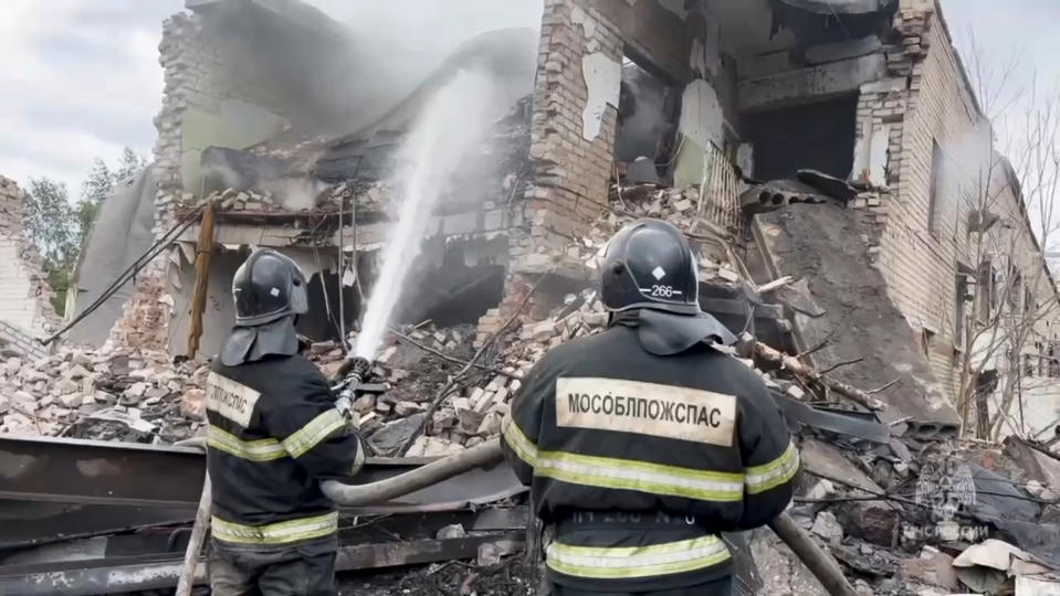 In this photo released by Russian Emergency Ministry Press Service on Wednesday, Aug. 9, 2023, firefighters work at the side of the Zagorsk Optical and Mechanical Plant after a blast in the city of Sergiev Posad, Moscow Region, about 65 km (41miles) north-east of Moscow, Russia. An explosion Wednesday, on the grounds of a factory north of Moscow that makes optical equipment for Russia's security forces wounded dozens people, six of them severely, officials said. The blast occurred at a warehouse storing fireworks, though it was on the grounds of the Zagorsk optics manufacturing plant, according to Andrei Vorobyov, the governor of the region surrounding the Russian capital. (Russian Emergency Ministry Press Service via AP)