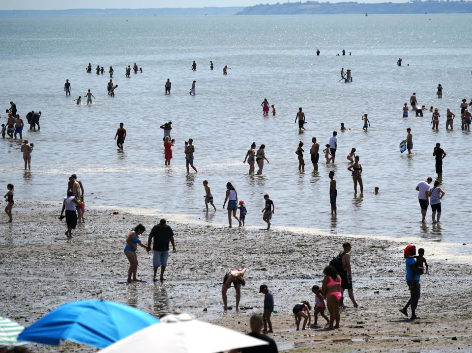 People relax on the beach at Southend-on-Sea on the Thames Estuary, in Essex (PA)