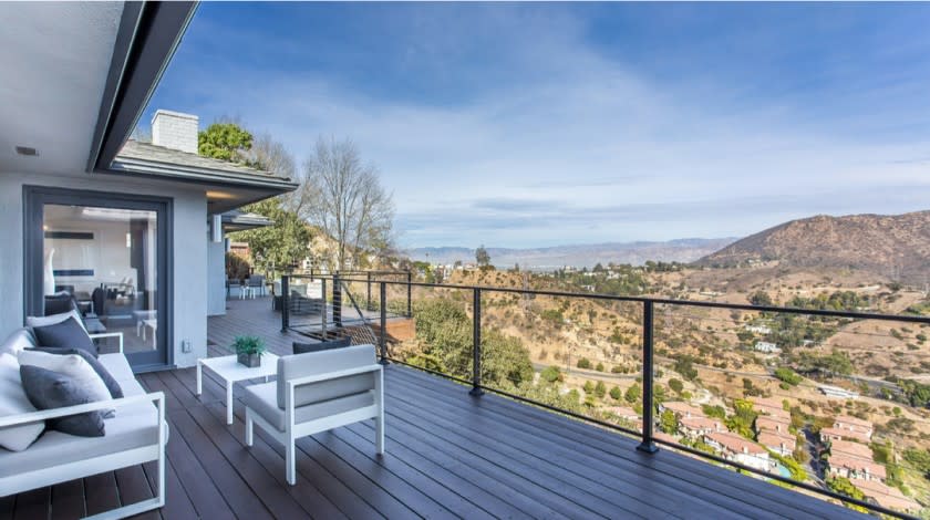 The clean, contemporary home expands to a spacious deck that takes in sweeping views of Griffith Park and the Hollywood Sign.
