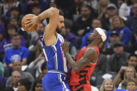 Sacramento Kings forward Trey Lyles, left, is guarded by Portland Trail Blazers Taze Moore during the first half of an NBA basketball game in Sacramento, Calif., Sunday, April 14, 2024. (AP Photo/Randall Benton)