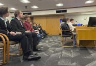 In a hearing room at the Oregon State Capitol in Salem, Ore., Thursday, March 9, 2023, high school students testify, at right, and others sit, awaiting their turn to do so, in support of a bill that would require climate change instruction in public schools from kindergarten through 12th grade. The students said climate change was an issue they cared about deeply. (AP Photo/Claire Rush)
