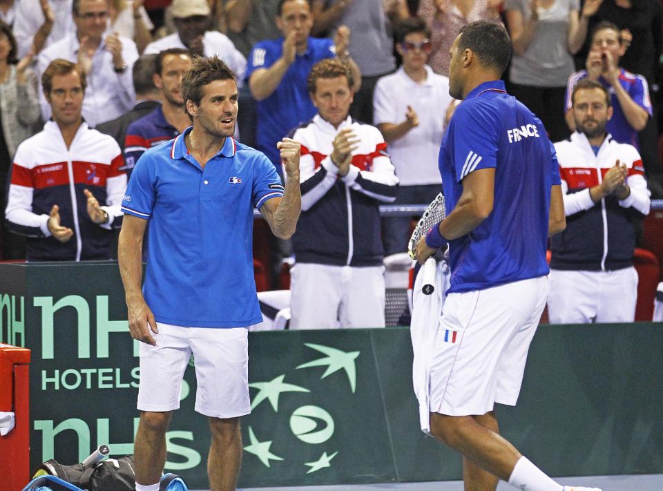 French tennis player Jo-Wilfried Tsonga, right, gets encouragements from French team coach Arnaud Clement, left, during his single match against German player Tobias Kamke, in the quarterfinals of the Davis Cup between France and Germany, in Nancy, eastern France, Sunday April 6, 2014.(AP Photo/Remy de la Mauviniere)