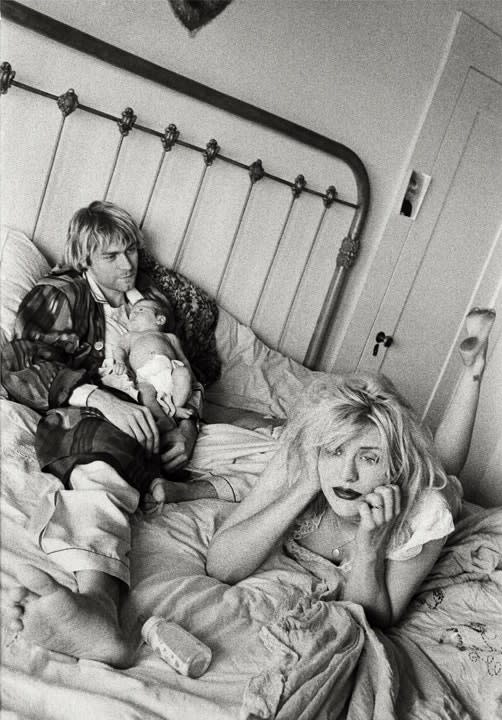 Black and white photo of Kurt Cobain and Courtney Love in bed with Francis