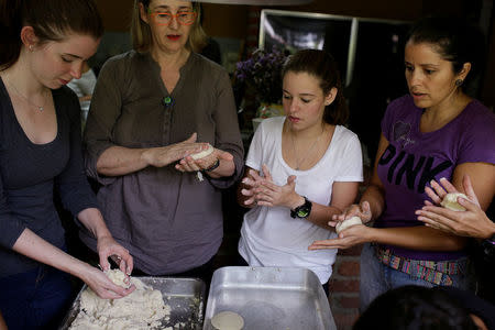 Volunteers of the Make The Difference (Haz La Diferencia) charity initiative prepare arepas to be donated, at the home kitchen of one of the volunteers in Caracas, Venezuela March 5, 2017. REUTERS/Marco Bello