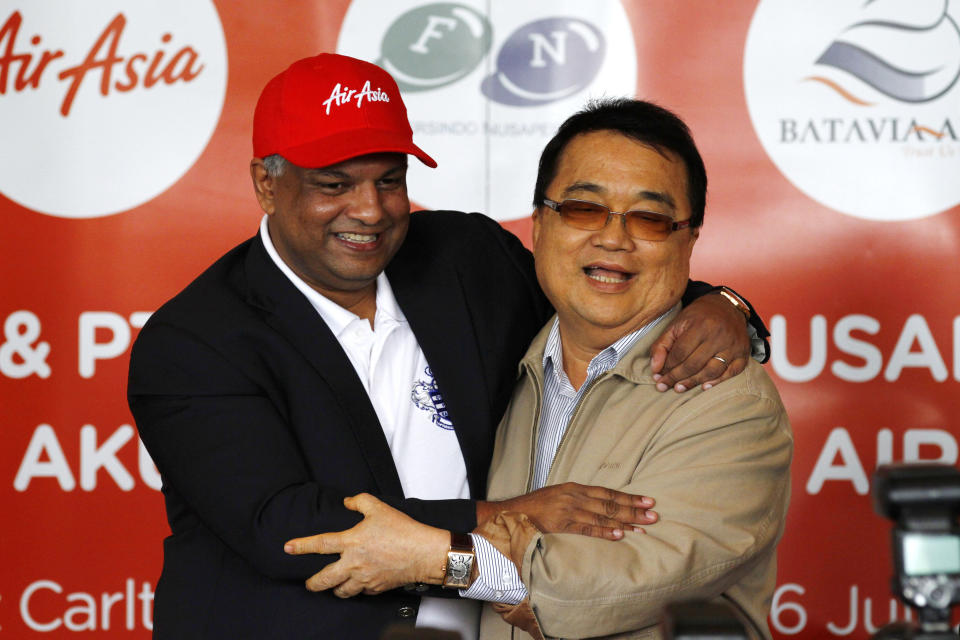 AirAsia Chief Executive Officer Tony Fernandez, left, hugs Batavia Air President Director Yudiawan Tansari during a joint press conference in Jakarta, Indonesia, Thursday, July 26, 2012. Low-cost airline AirAsia said it is buying Indonesian budget carrier Batavia Air to expand in Southeast Asia's biggest economy. (AP Photo/Achmad Ibrahim)