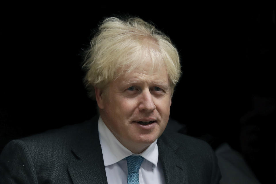 British Prime Minister Boris Johnson leaves 10 Downing Street in London, to attend the weekly Prime Minister's Questions at the Houses of Parliament, in London, Wednesday, Sept. 16, 2020. (AP Photo/Matt Dunham)