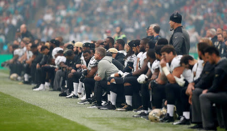 NFL Football - Miami Dolphins vs New Orleans Saints - NFL International Series - Wembley Stadium, London, Britain - October 1, 2017 New Orleans Saints players take the knee before the start of the national anthem Action Images via Reuters/Matthew Childs