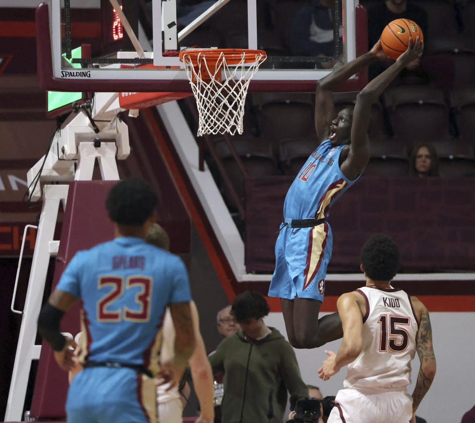 Florida State's Taylor Bol Bowen (10) scores in front of Virginia Tech's Lynn Kidd (15) during the first half of an NCAA college basketball game Tuesday, Feb. 13, 2024, in Blacksburg, Va. (Matt Gentry/The Roanoke Times via AP)