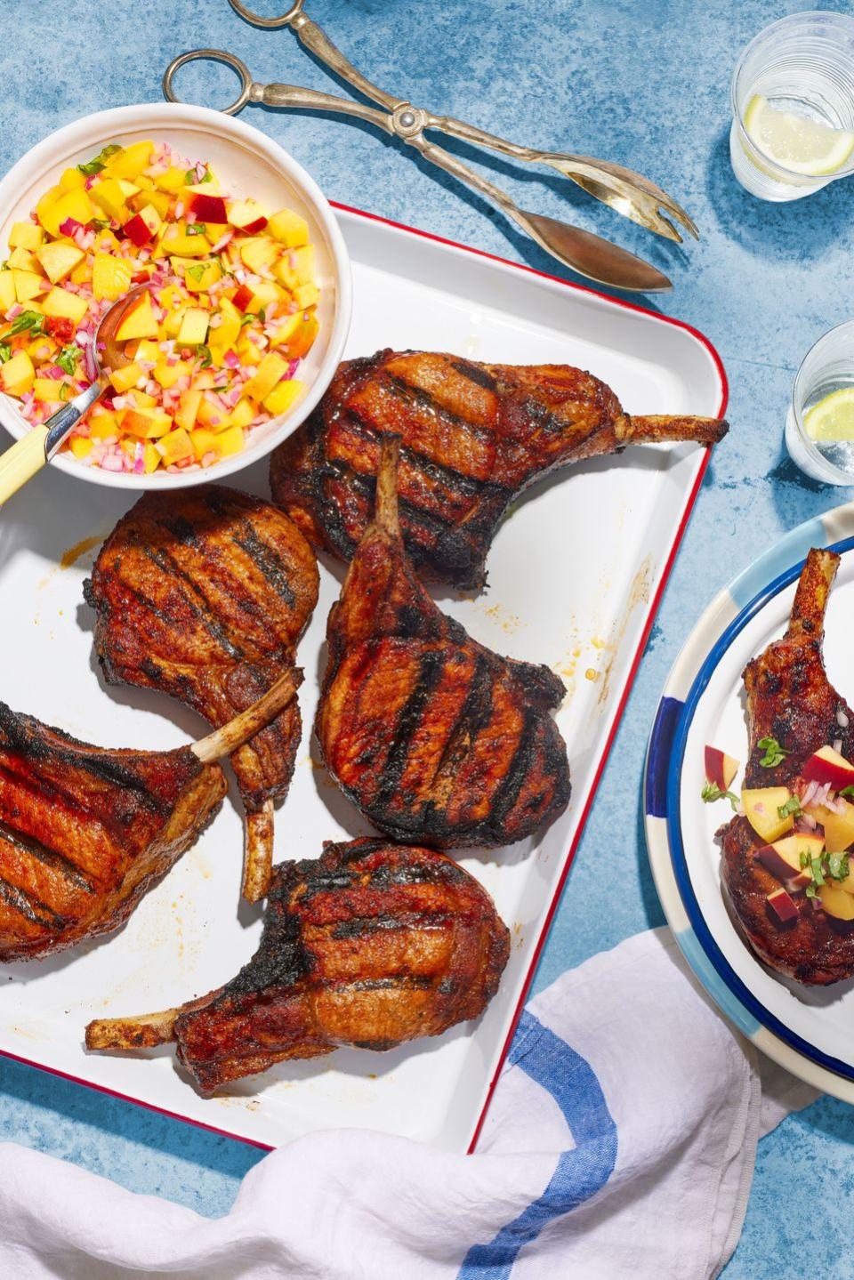 smoky grilled dry rub pork chops on a white serving tray