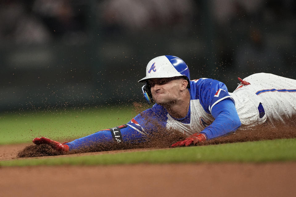 Atlanta Braves' Sam Hilliard slides into second base with a double in the eighth inning of a baseball game against the San Diego Padres, Saturday, April 8, 2023, in Atlanta. (AP Photo/John Bazemore)