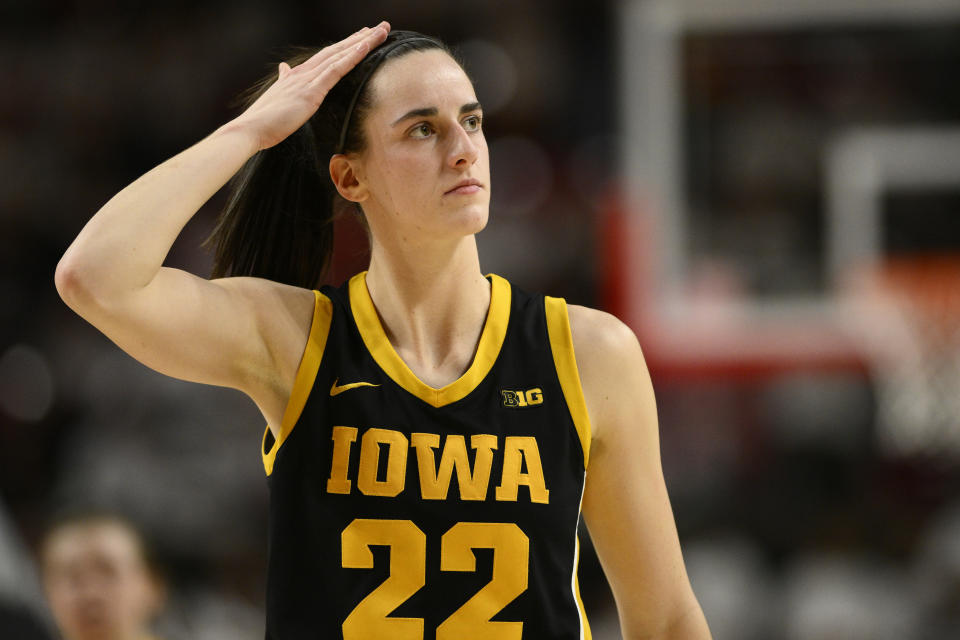 Iowa guard Caitlin Clark (22) adjusts her hair during the second half of an NCAA college basketball game against Maryland, Saturday, Feb. 3, 2024, in College Park, Md. (AP Photo/Nick Wass)