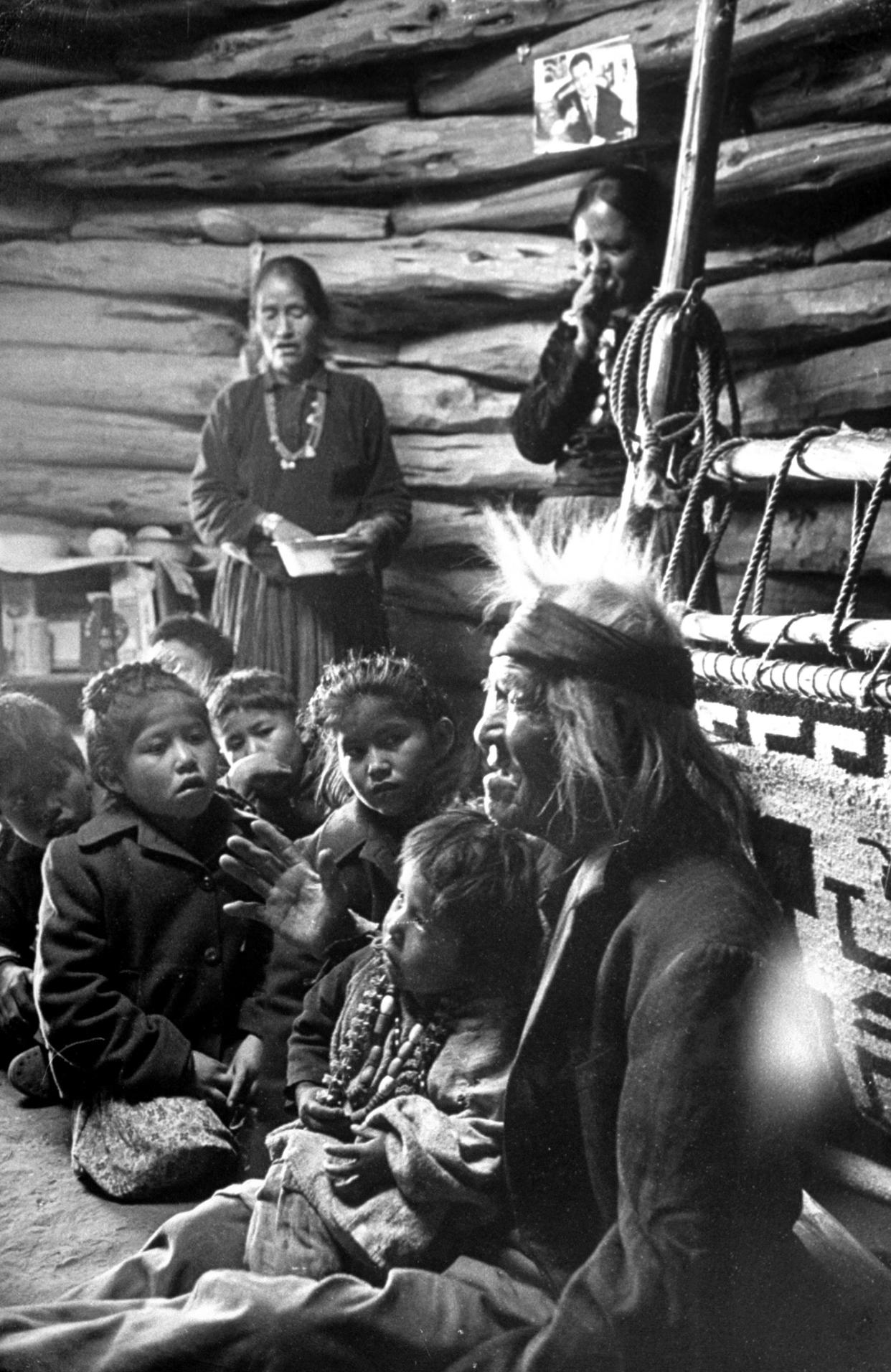 <b>Caption from LIFE.</b> Seated close to the evening fire, old man Gray Mountain, 91, tells his small grandchildren legends about the early days of the Navajo people.