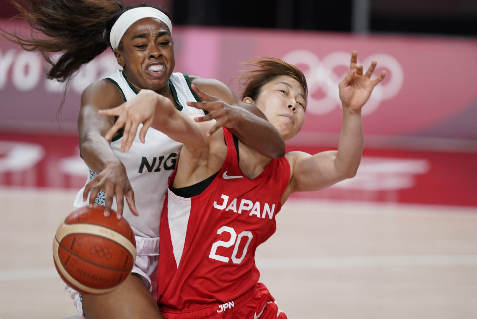 Nigeria's Erinma Ogwumike (31, left, tries to steal the ball from Japan's Nanako Todo (20) during women's basketball preliminary round game at the 2020 Summer Olympics, Monday, Aug. 2, 2021, in Saitama, Japan. (AP Photo/Charlie Neibergall)