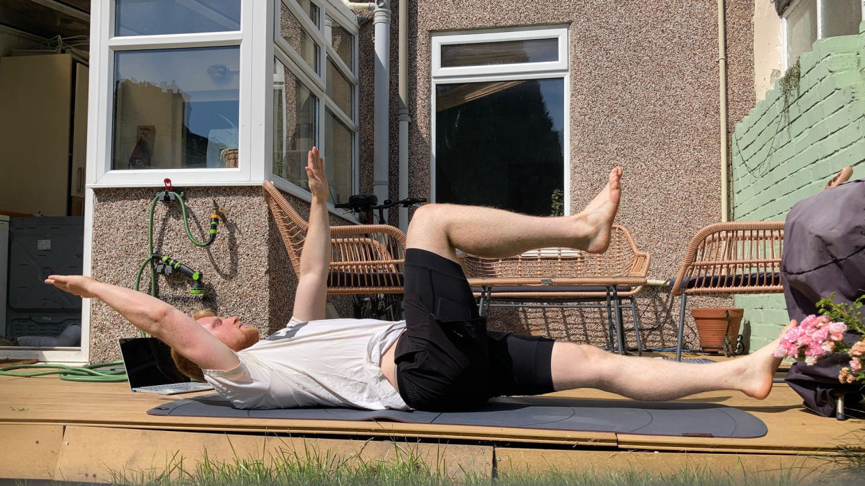  Author Harry Bullmore performing the dead bug exercise outside 